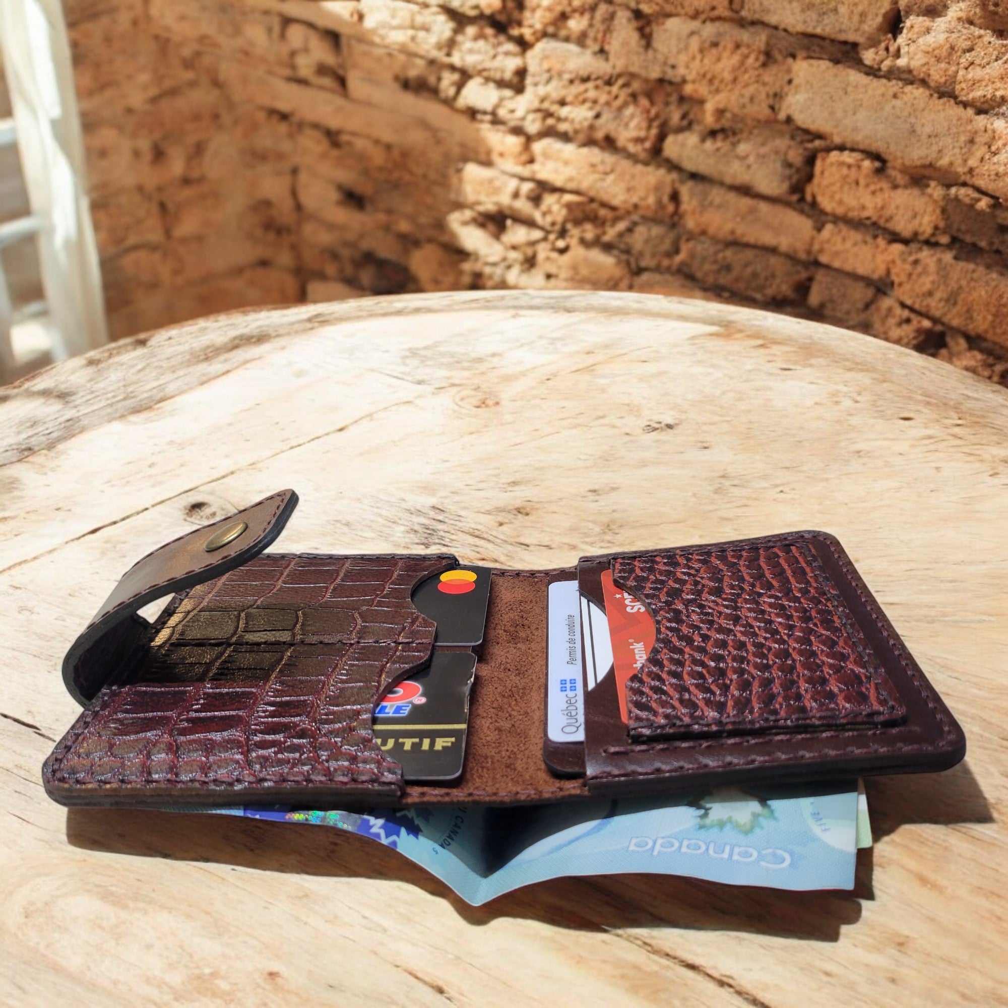 Compact wallet in premium natural leather with a rich, crocodile-embossed finish.