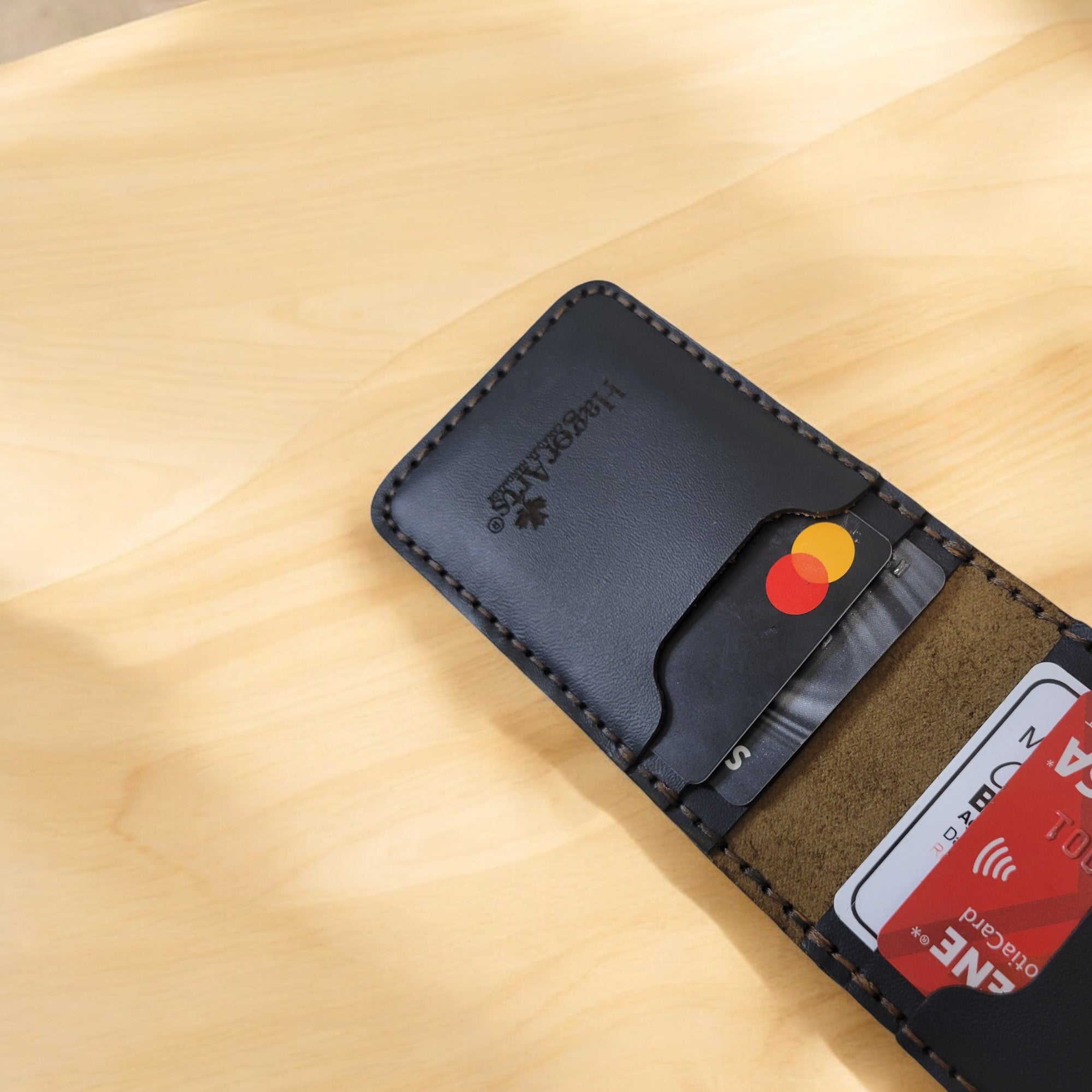 Hand-stitched leather cardholder from the Slimette Collection in tan brown, featuring 6 slots & 2 hidden pockets