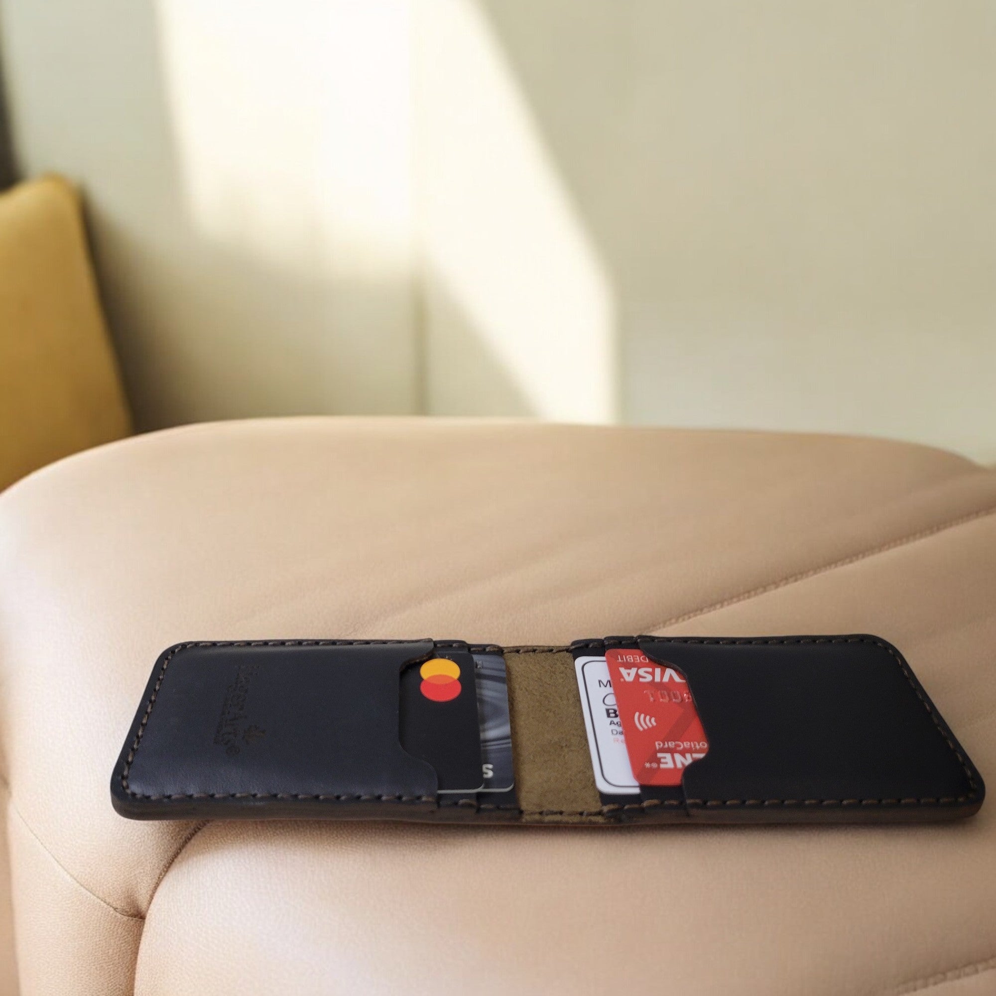 Minimalist leather cardholder in rich brown and black, designed for a sleek and stylish way to carry your cards and cash.