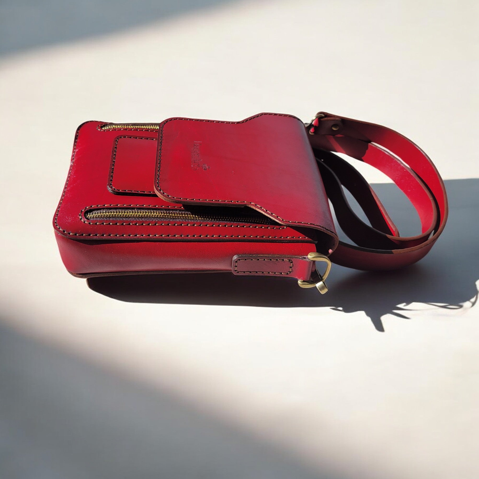 Luxury red leather crossbody bag featuring a front cardholder, secure zippers, and artisan craftsmanship – Élan Collection M1.