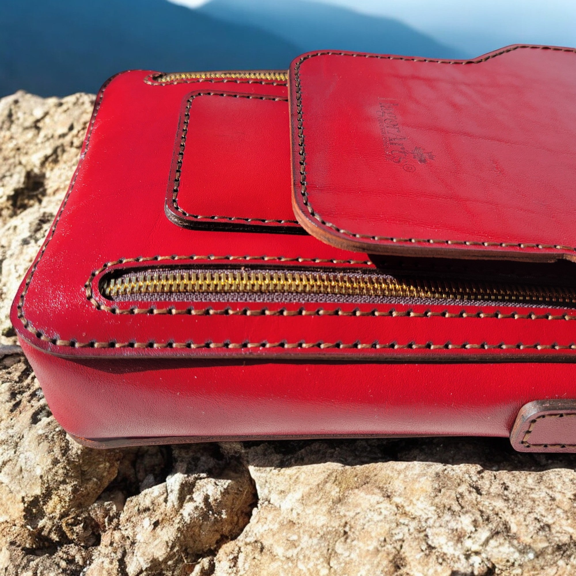 HagorArts handmade leather crossbody bag with a sleek red finish, perfect for modern professionals and travelers