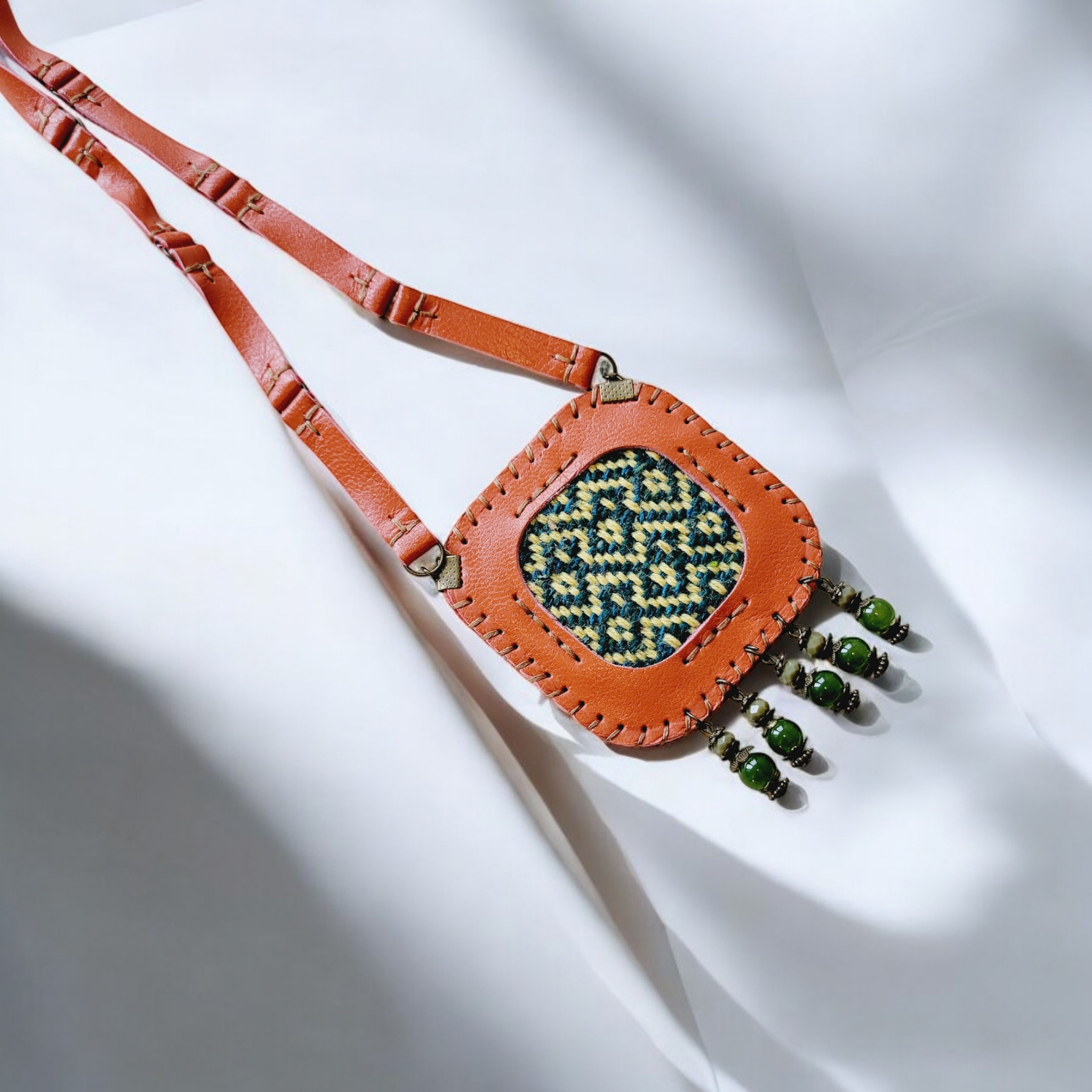 Bead tassels in olive-green tones; structured back for comfort against the skin.