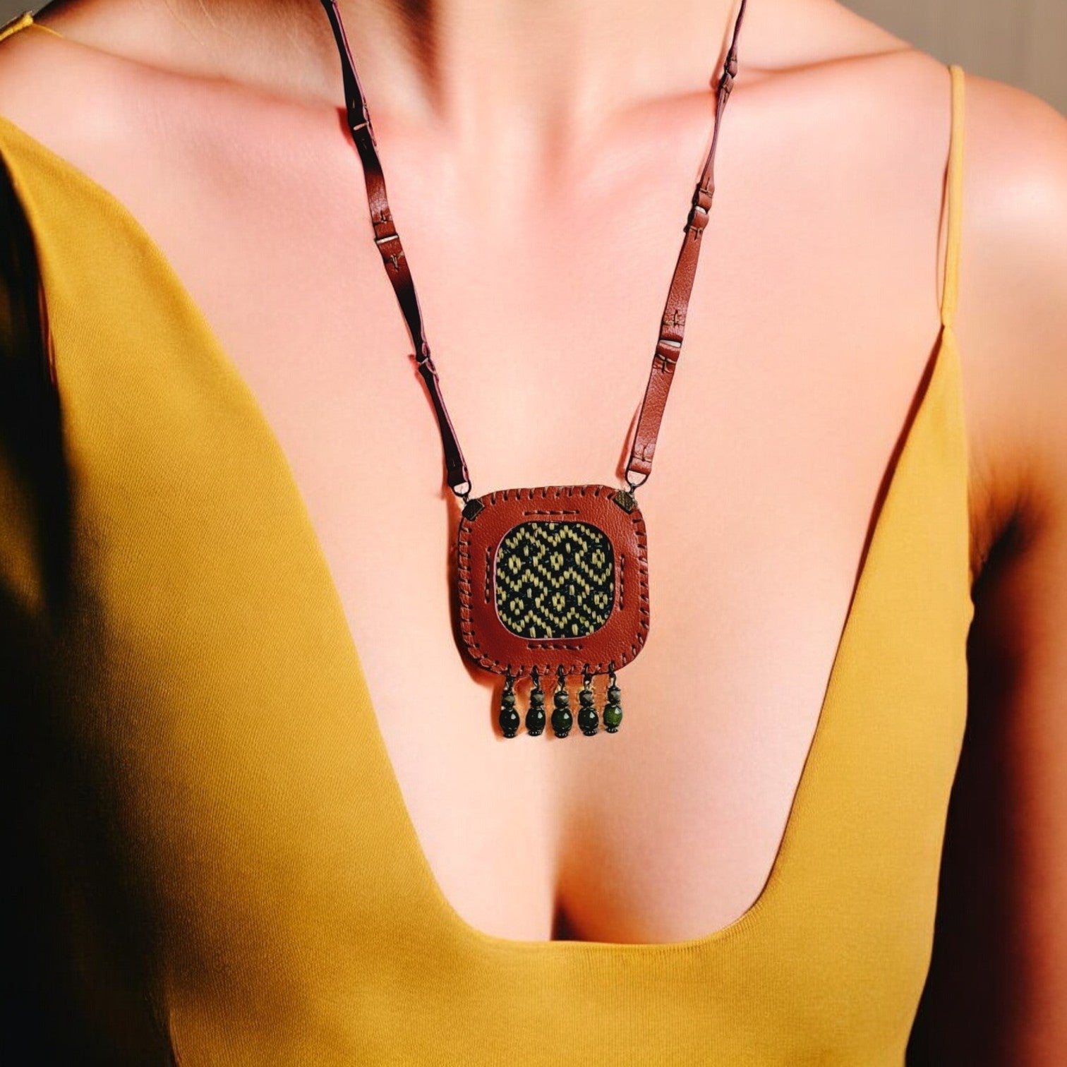 Close-up of orange leather frame with geometric woven panel and whip-stitching — Velora C4