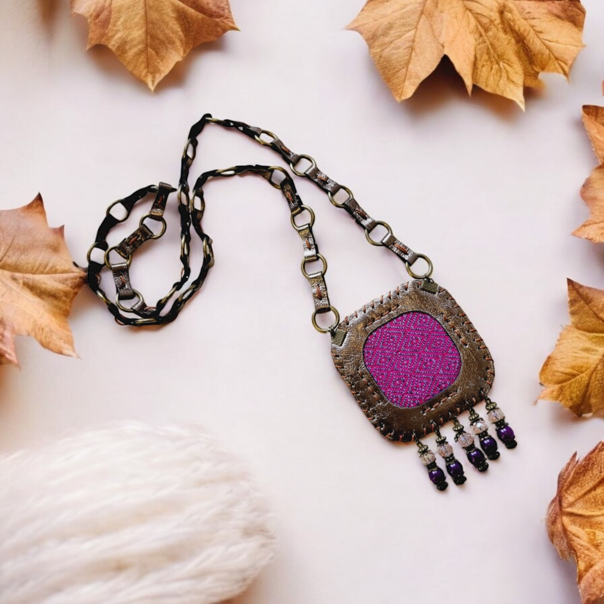 Close-up of copper leather frame with whip-stitch around violet woven panel: HagorArts Velora C6.