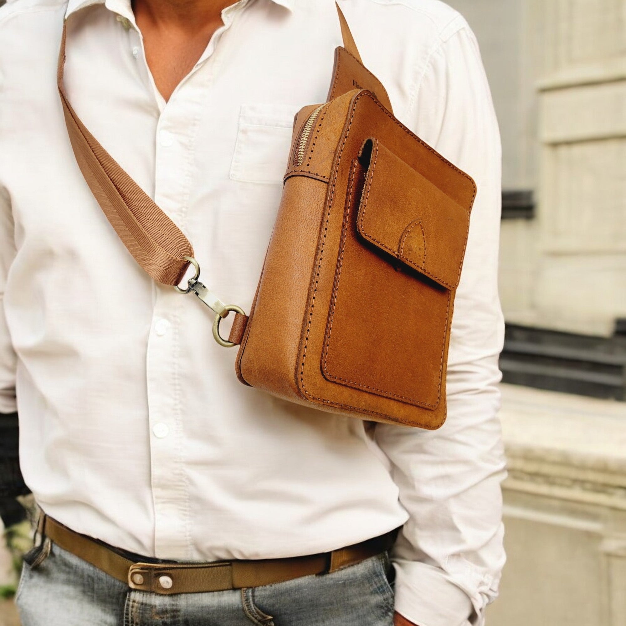 Close-up of tan full-grain leather sling with crisp stitching — HagorArts Odyssey C1.