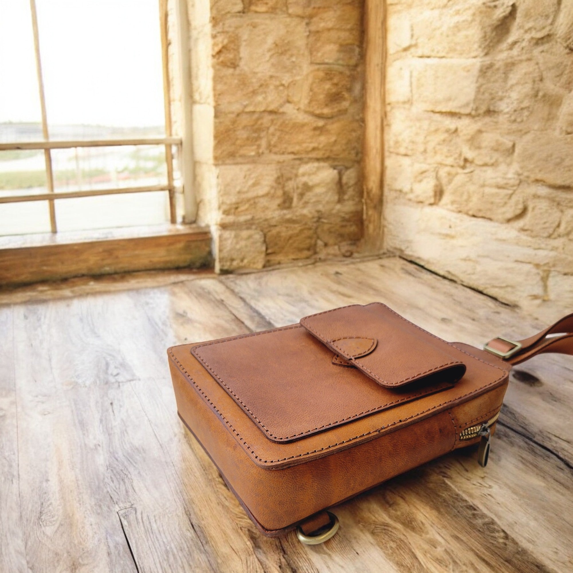 Close-up of tan full-grain leather sling with crisp stitching, HagorArts Odyssey C1, Canadian Handmade