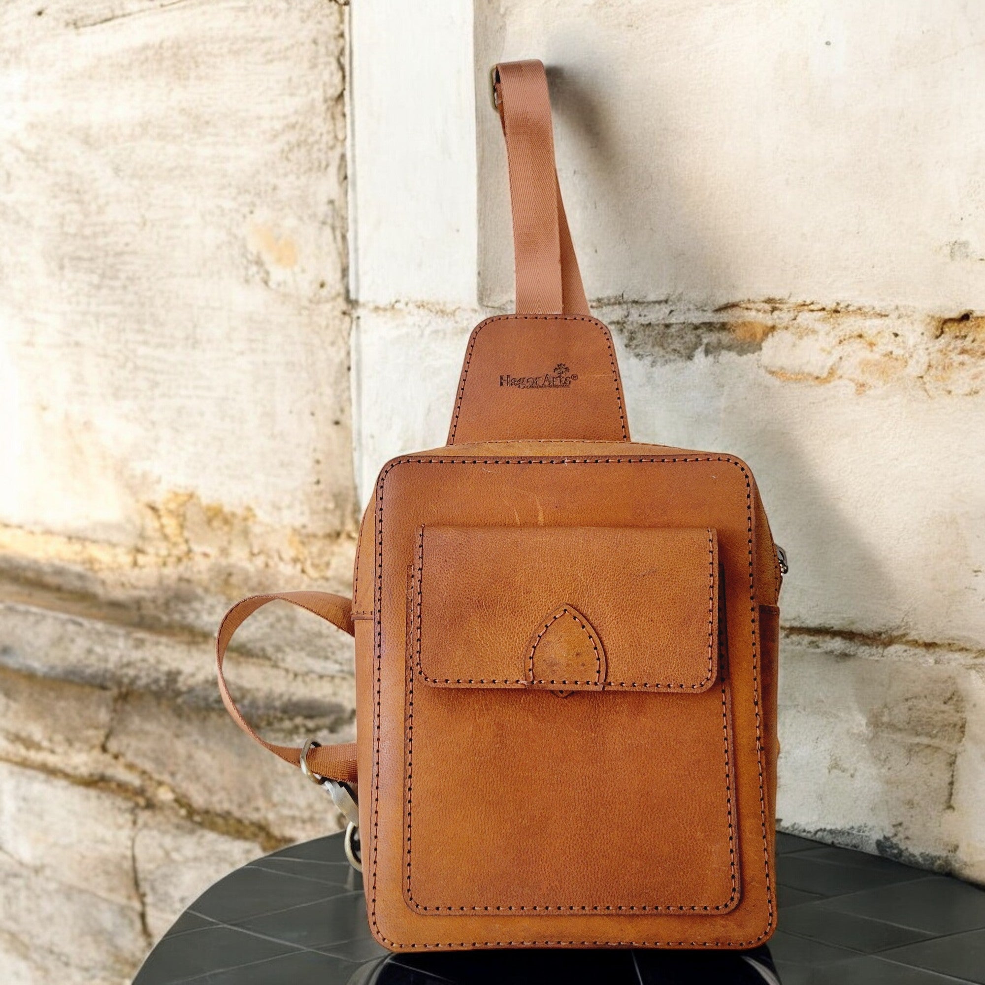 Compact tan leather crossbody sling, handcrafted in Canada (Odyssey C1).