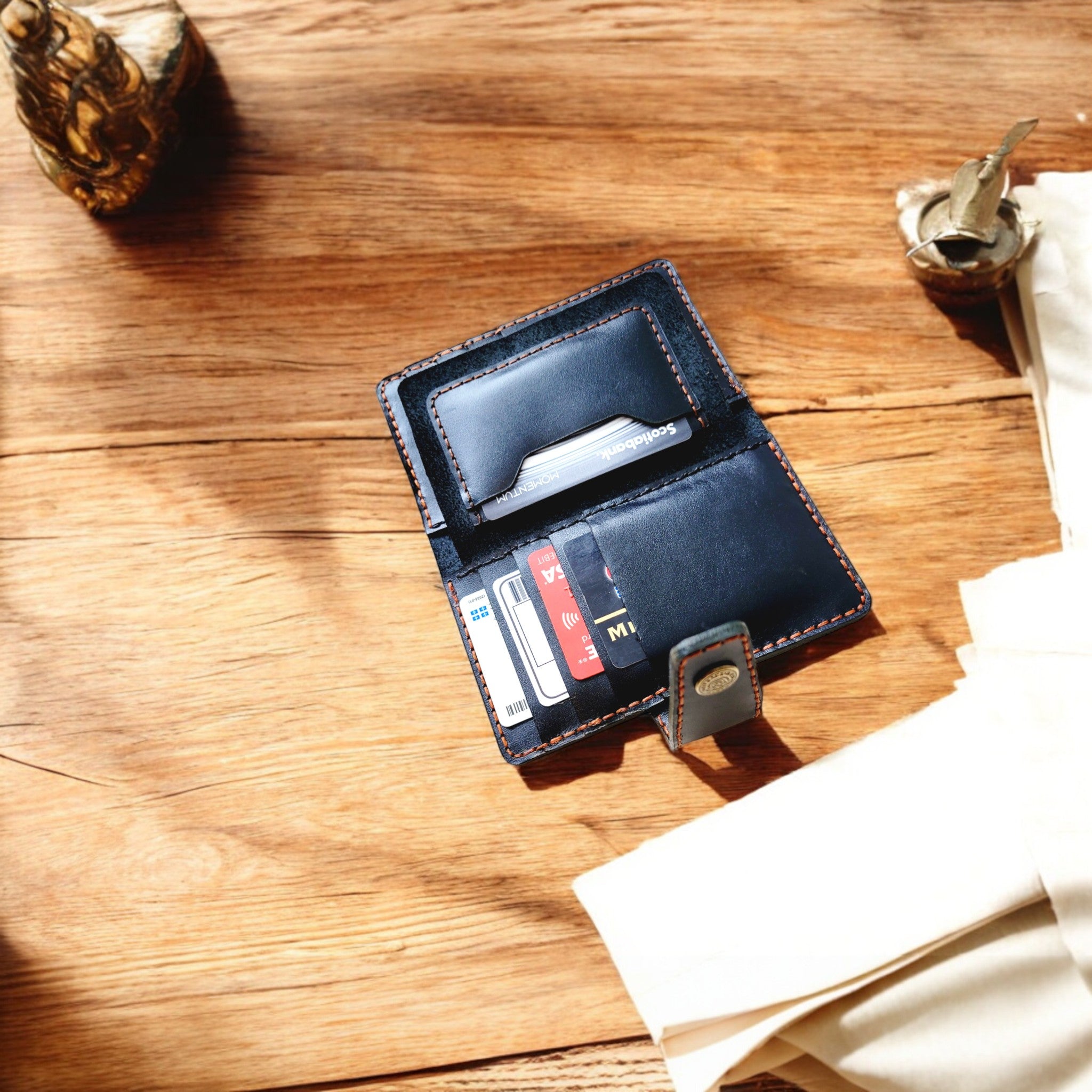 Open black leather cardholder showcasing 12 card slots and 2 interior pockets.