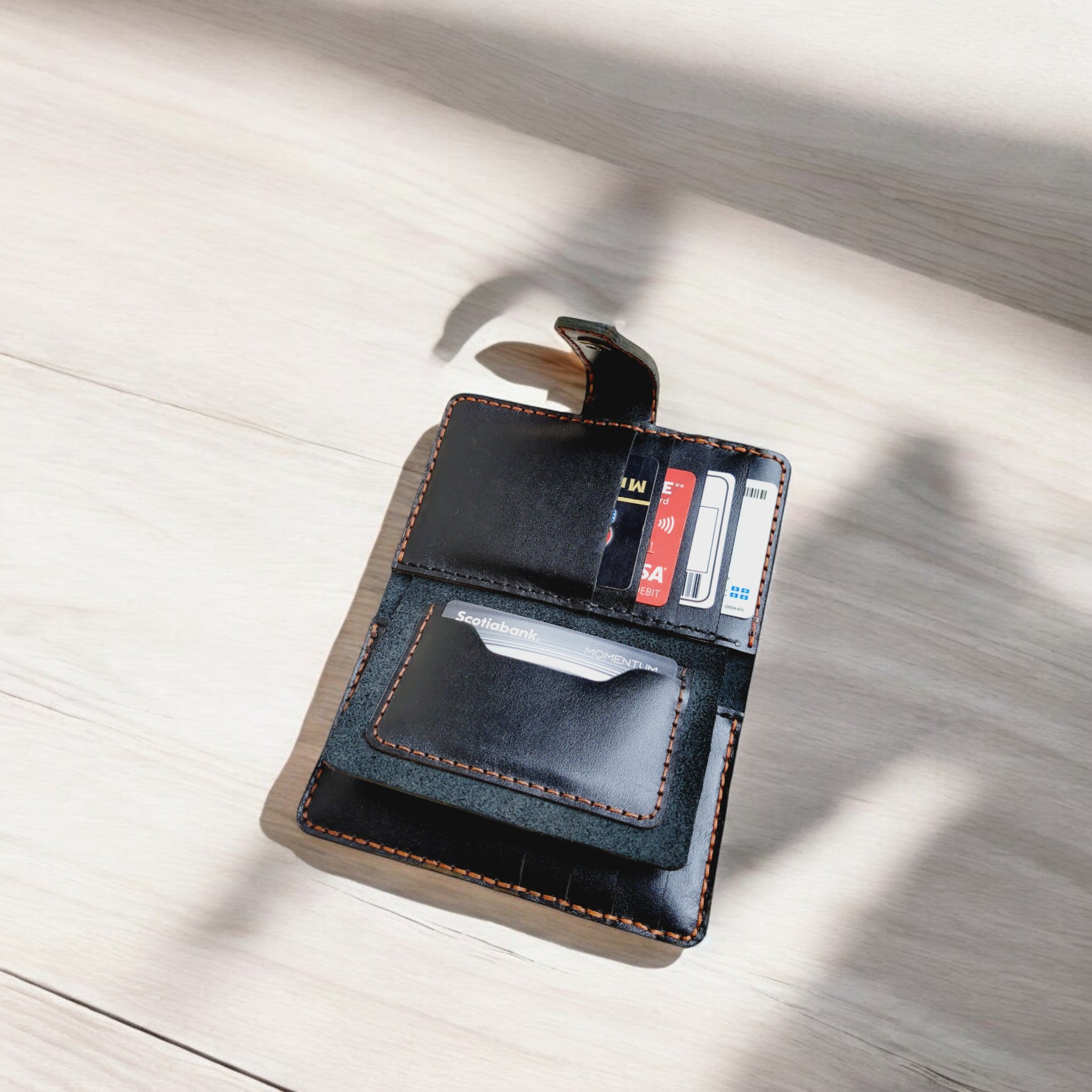 Handcrafted black leather wallet with fine detailing and a smooth texture.